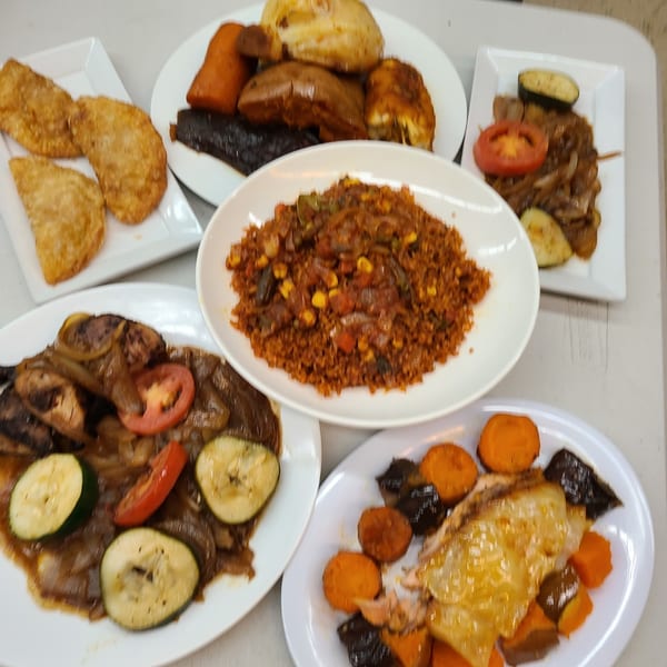 A variety of Senegalese dishes, including rice, fried pastries, and meat with vegetables.